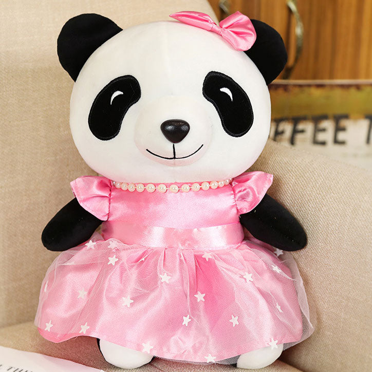 Stuffed animal toy in pink dress